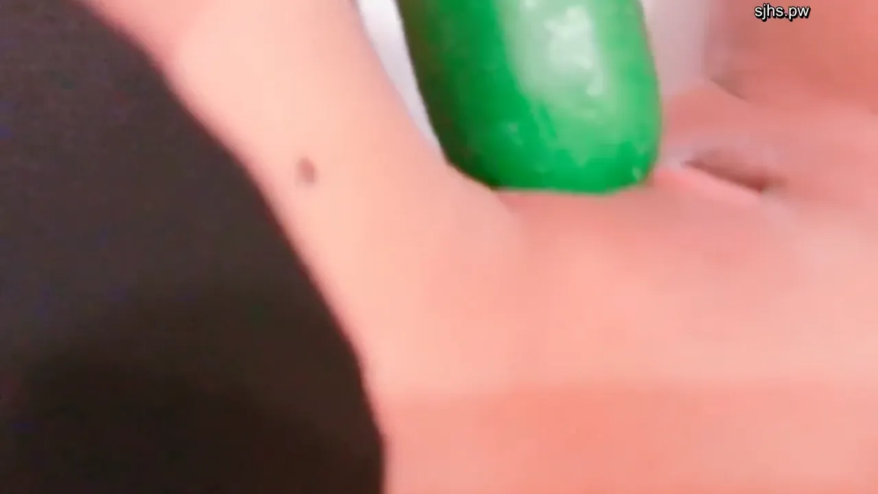 Sexy Asian school student girl plays solo with a cucumber in a WC