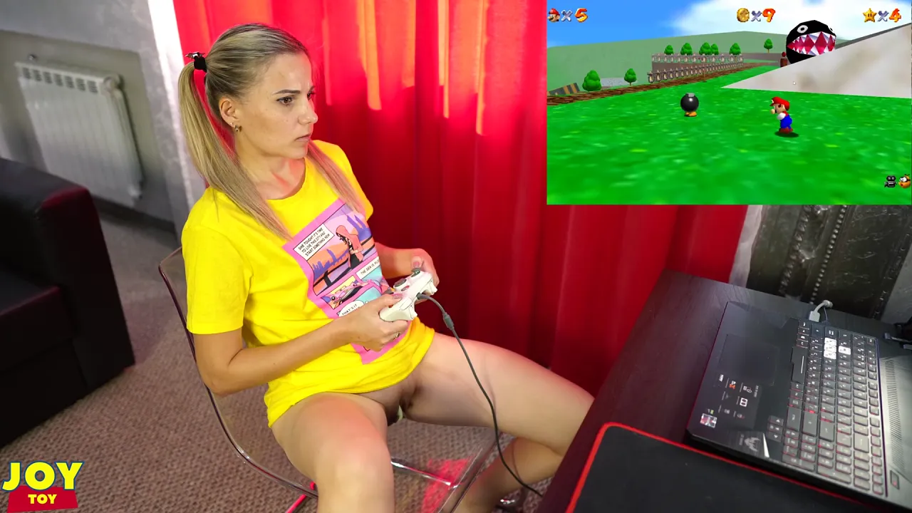 Blonde Letty Black plays retro games with remote vibrator in her pussy, orgasming as she