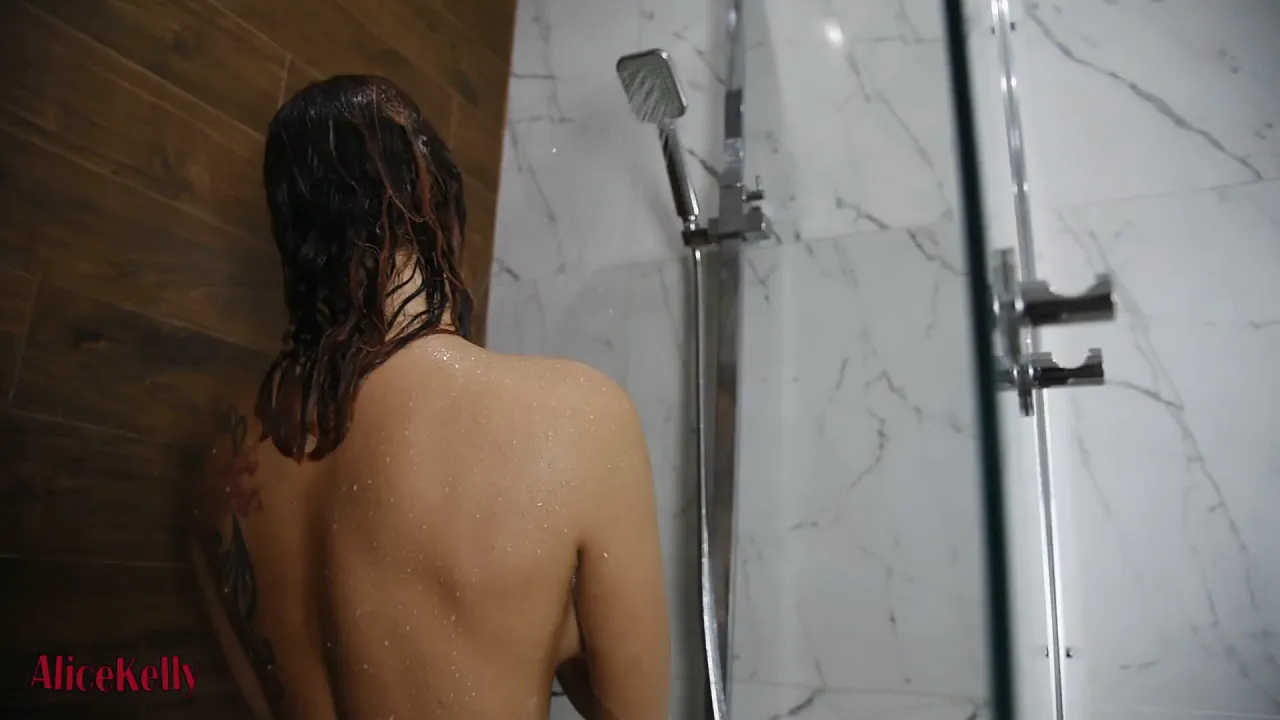 Solo babe masturbates with a black dildo in the shower