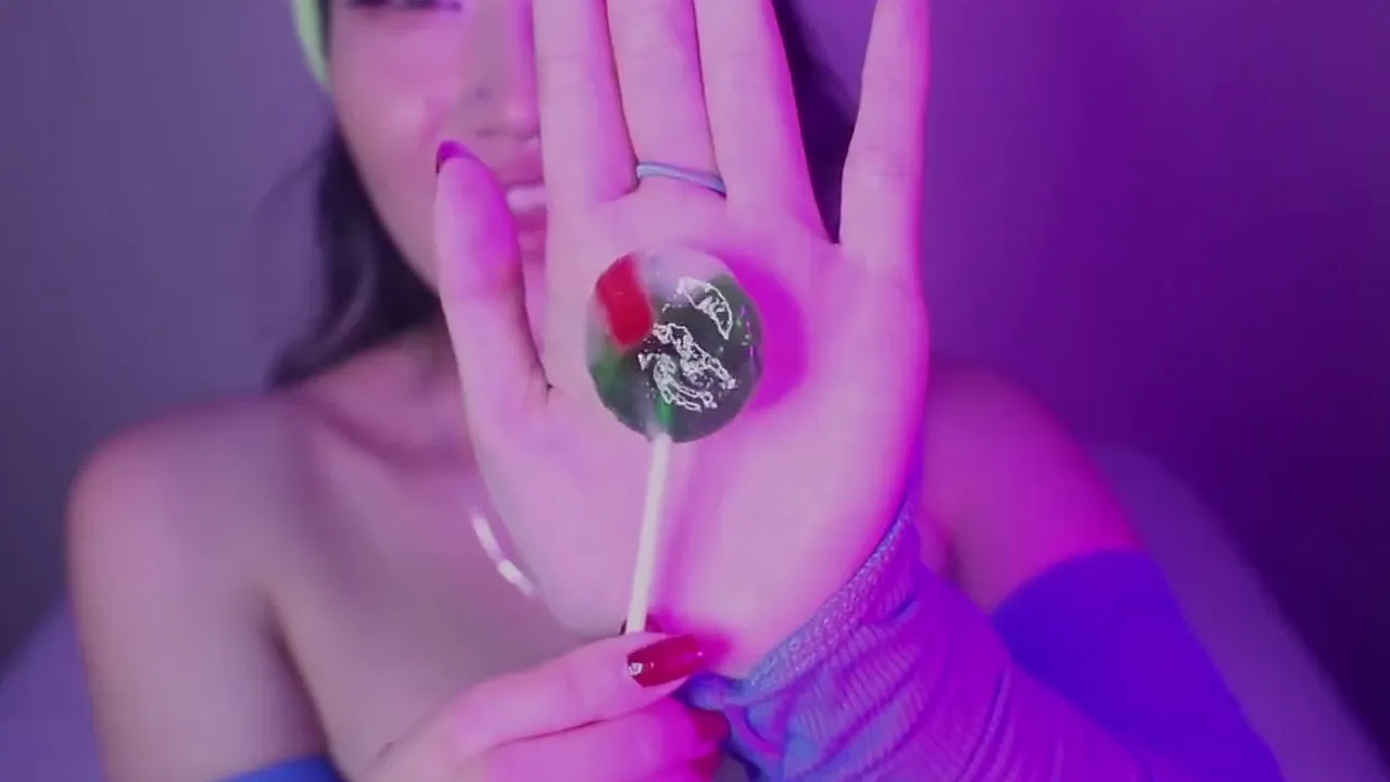 Asian webcam model shows small natural boobs and licks a lollipop