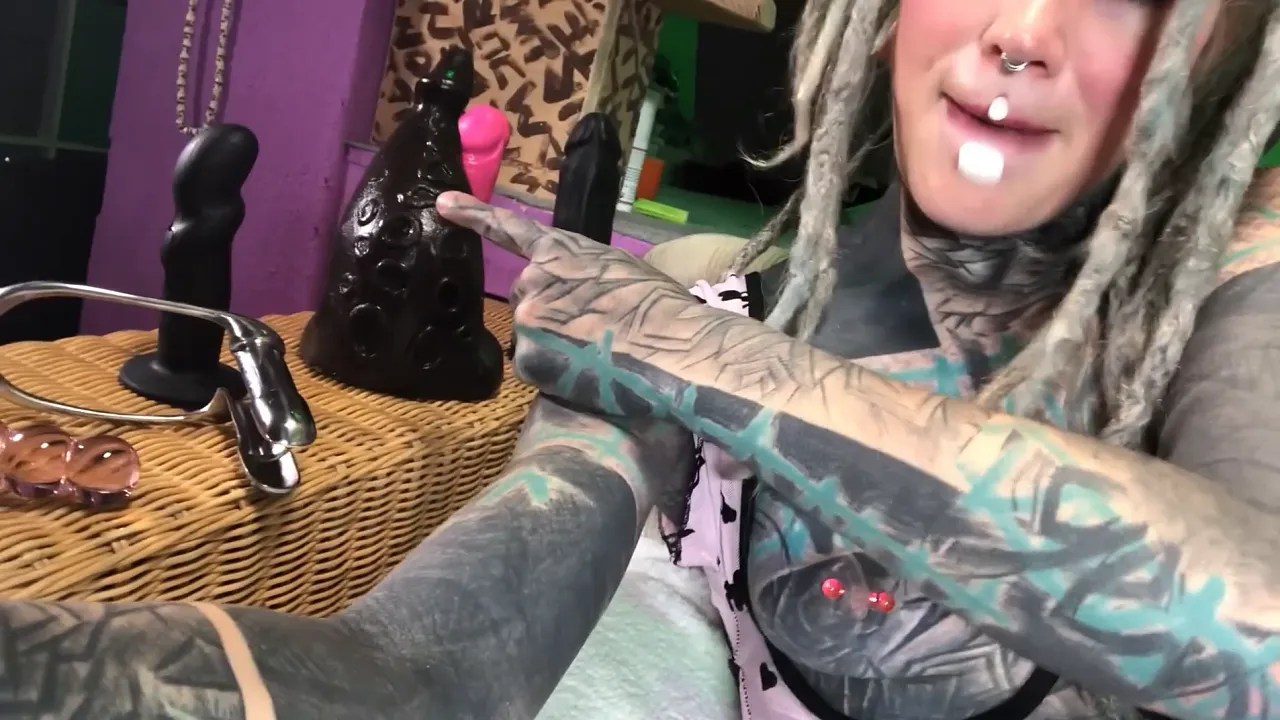 Tattooed Anuskatzz shows off her butt plug and masturbates with toys