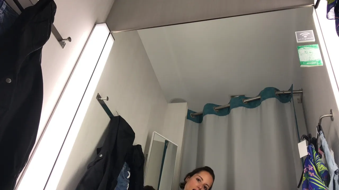 Sexy brunette masturbates in public changing room