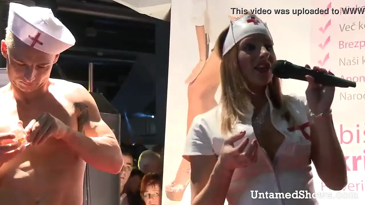 Stripper nurse strips and masturbates with a dildo on stage