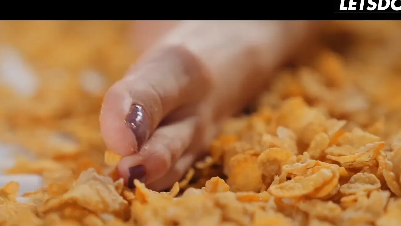 Tattooed redhead masturbates to orgasm with fingers in a bed of cereal