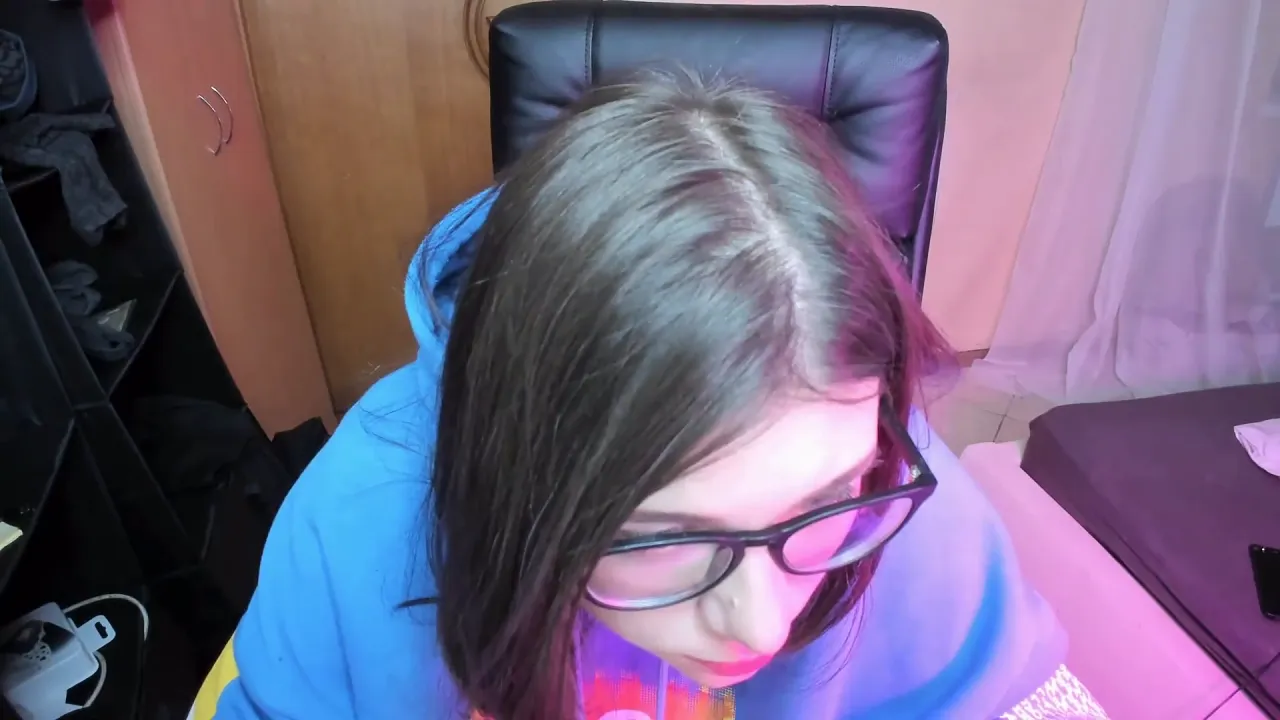 Cute cam girl with glasses quietly sucks dildo on webcam