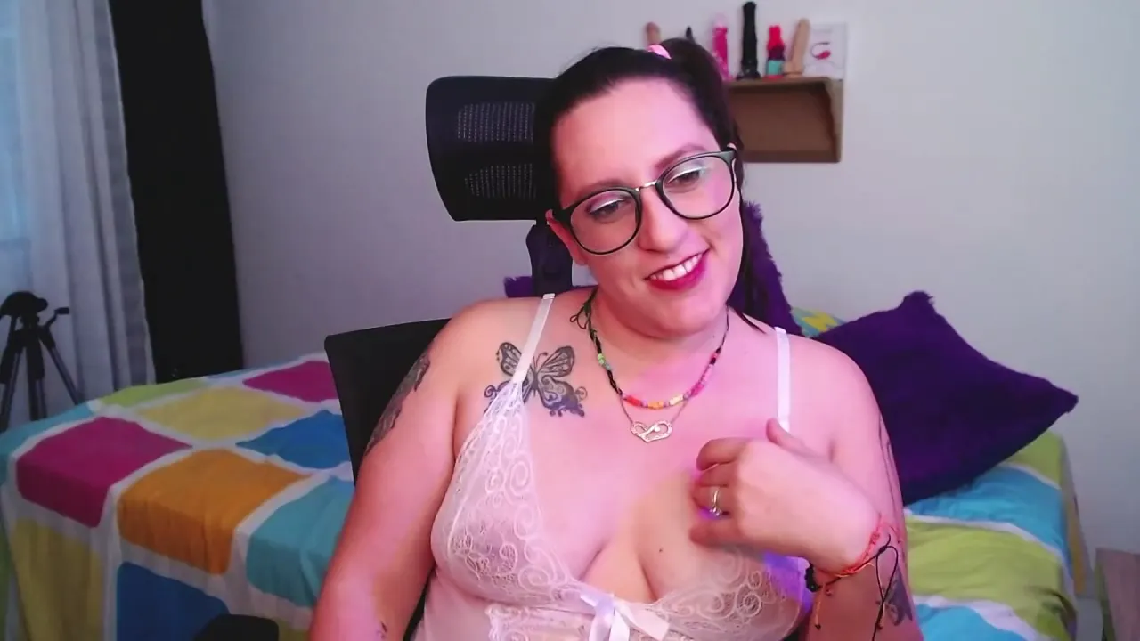 Tattooed webcam model smiles at the camera