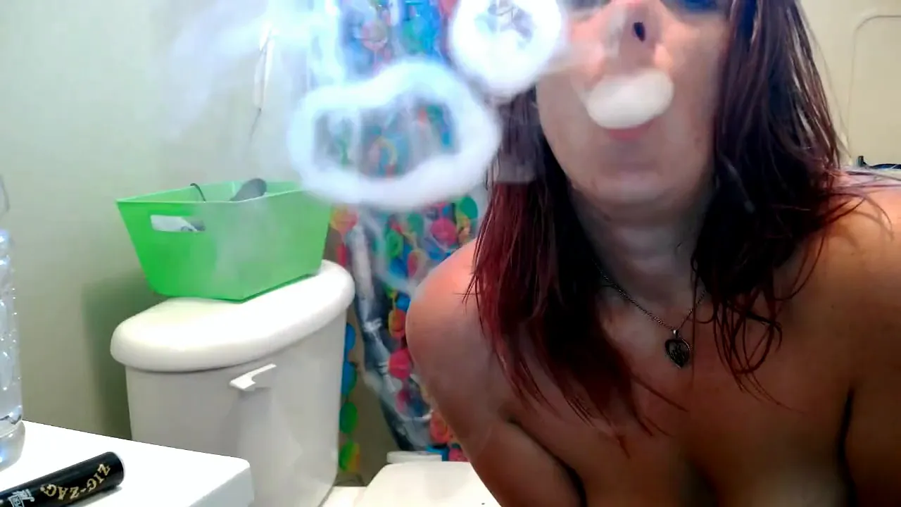 MILF Molly Devine smokes a cigarette and strips naked on webcam in the bathroom