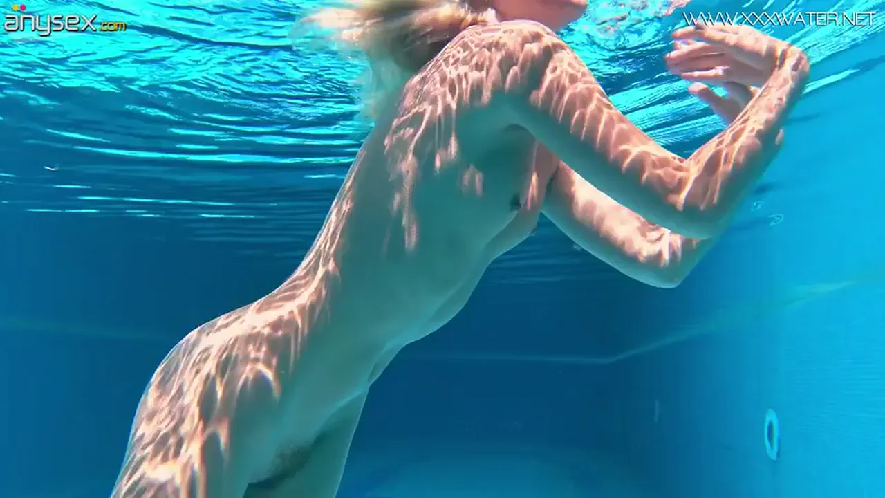 Mary Kalisy stripteases and masturbates her small tits pussy underwater