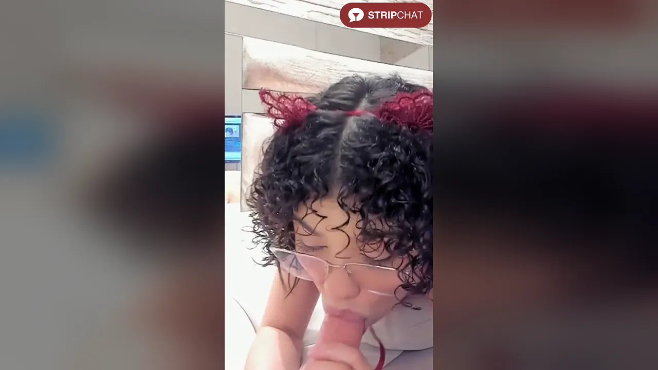 Chloe Cortez, a skinny Latina with curly hair and glasses, deepthroats a dildo on webcam